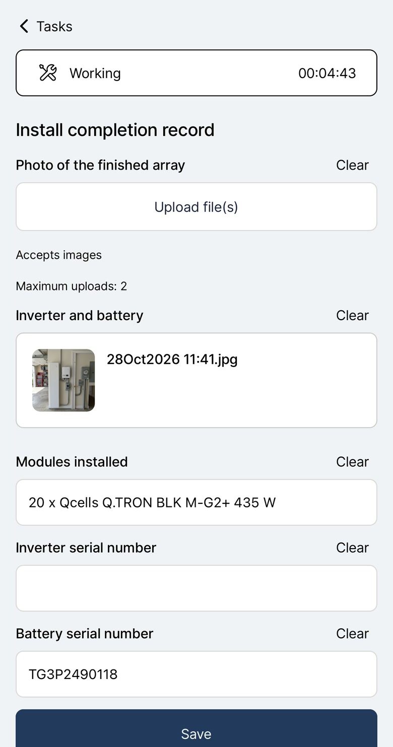 The Payaca field app on install day, the crew lead entering the inverter serial and adding a photo of the finished array to the install record for the same project